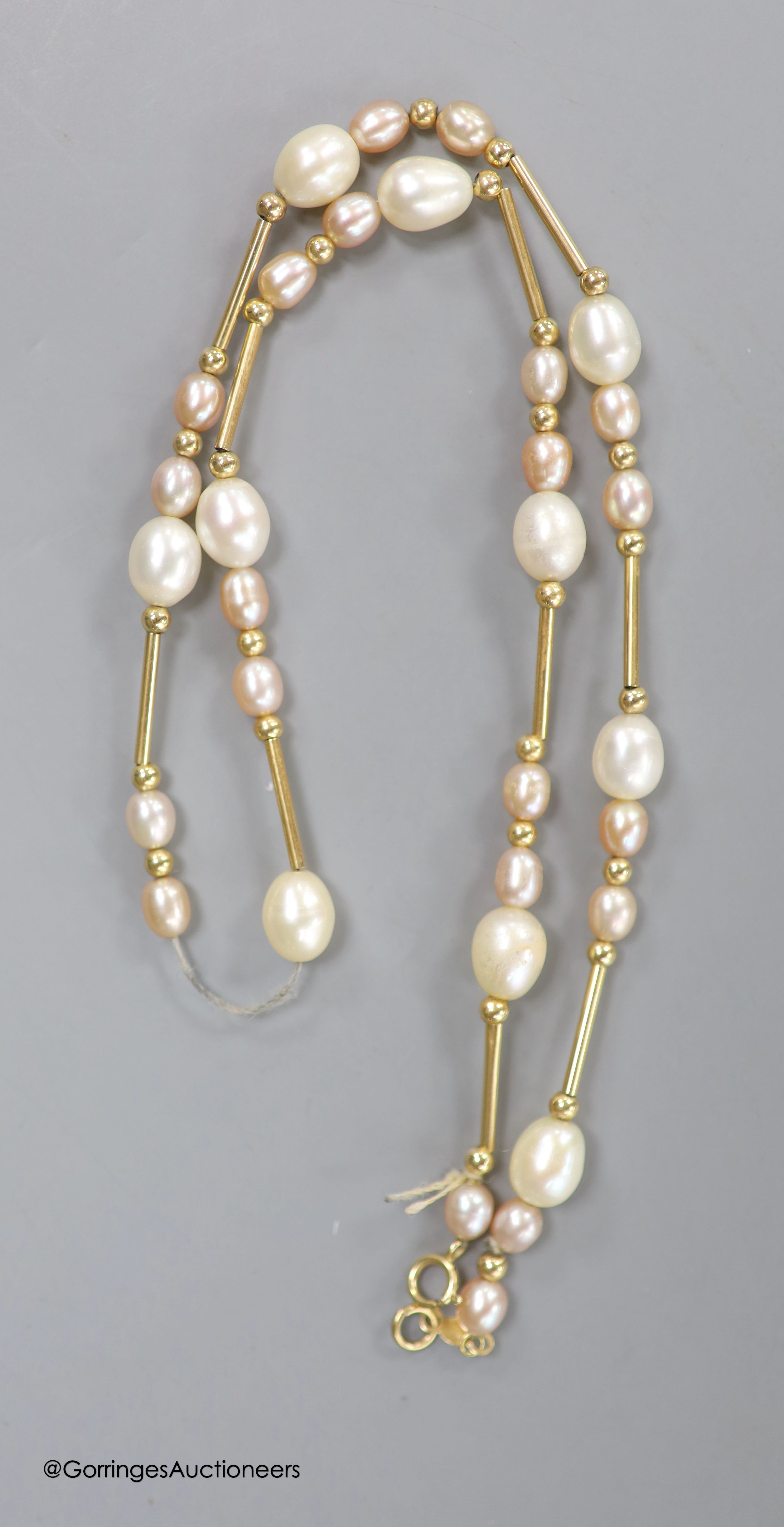 A modern 14kt yellow metal and graduated cultured pearl bar and cluster set necklace, 44cm, gross weight 11.3 grams.